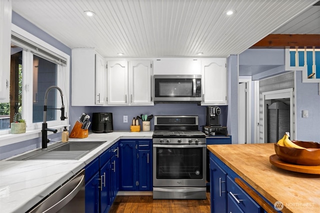 4130 Lakeway Dr, Bellingham, WA 98229 - kitchen with a sink, white cabinetry, appliances with stainless steel finishes, and blue cabinets