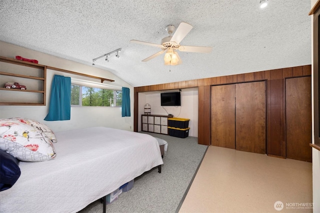 4130 Lakeway Dr, Bellingham, WA 98229 - bedroom featuring ceiling fan, a textured ceiling, rail lighting, lofted ceiling, and carpet