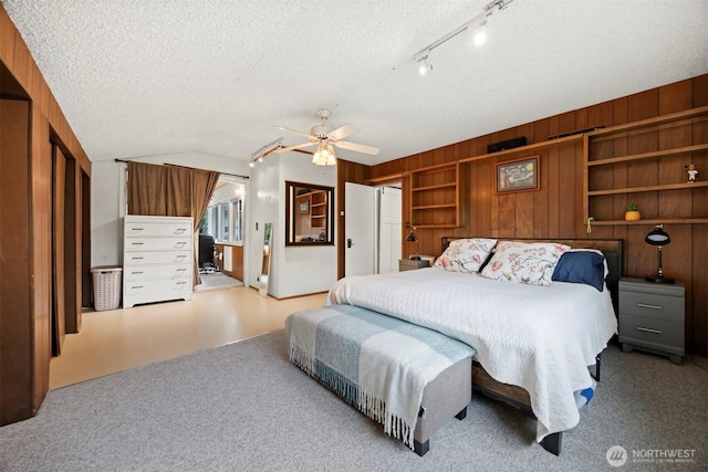 4130 Lakeway Dr, Bellingham, WA 98229 - bedroom featuring carpet, a textured ceiling, a ceiling fan, and wooden walls