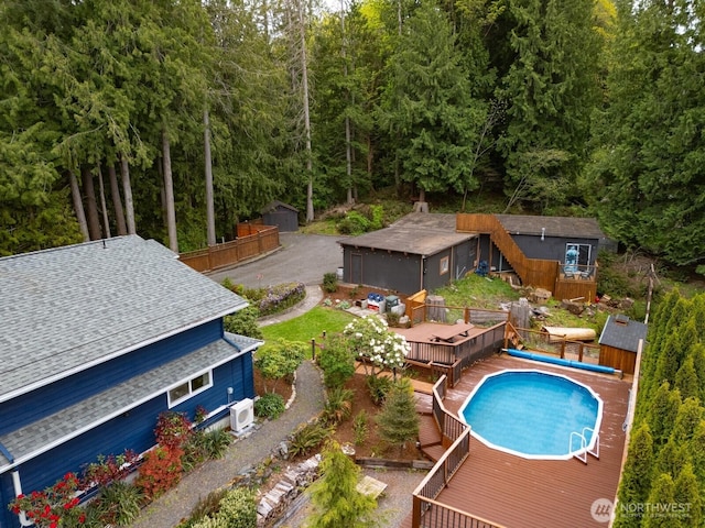 4130 Lakeway Dr, Bellingham, WA 98229 - view of swimming pool with a covered pool, fence, a deck, and a forest view