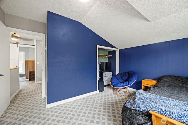 4130 Lakeway Dr, Bellingham, WA 98229 - bedroom with a textured ceiling, a barn door, and vaulted ceiling