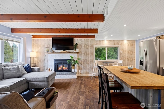 4130 Lakeway Dr, Bellingham, WA 98229 - living area with dark wood-style floors, plenty of natural light, a brick fireplace, recessed lighting, and a wooden ceiling with exposed beams