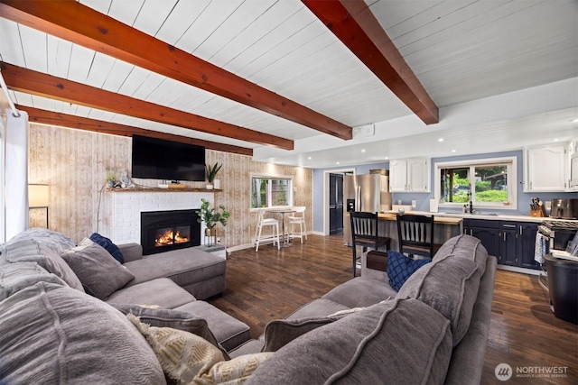 4130 Lakeway Dr, Bellingham, WA 98229 - living area with dark wood-style floors, beamed ceiling, and a brick fireplace