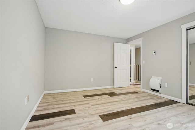 unfurnished bedroom with baseboards and wood finished floors