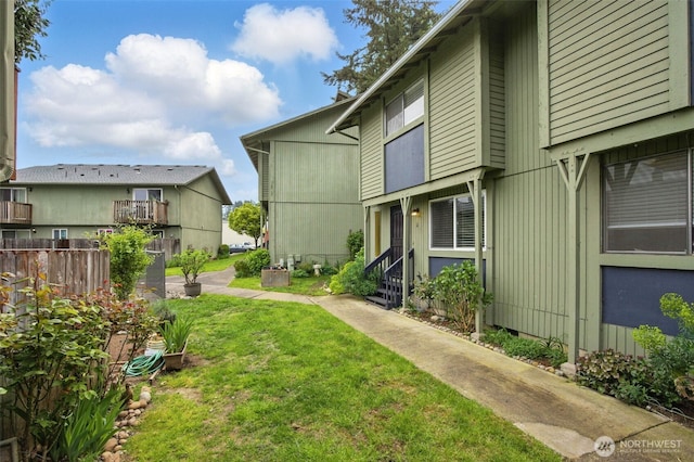 view of yard with fence and entry steps