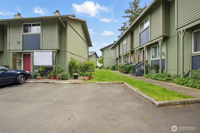 view of property with a residential view and uncovered parking