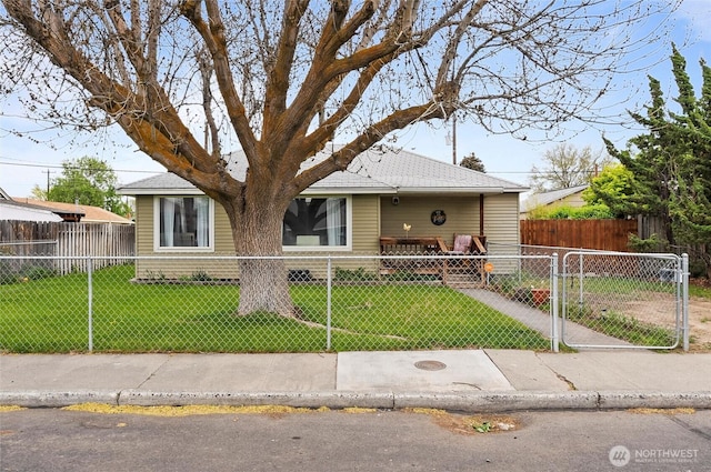 view of front of home with a gate, a fenced front yard, and a front yard