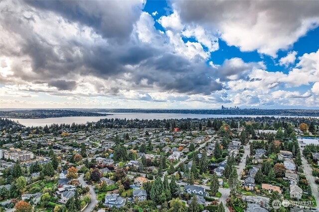 birds eye view of property with a residential view and a water view