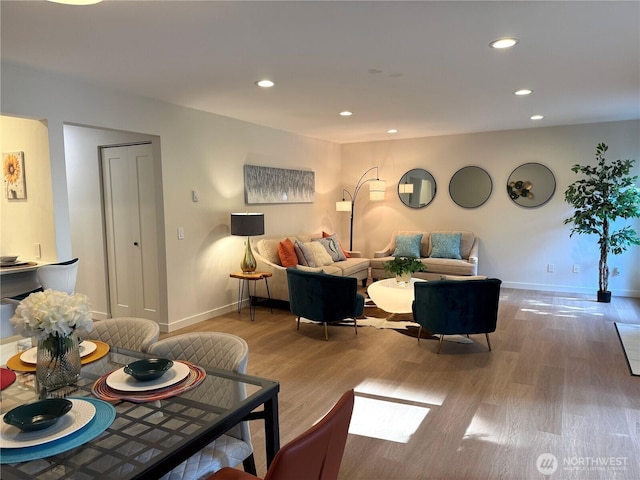 living area with recessed lighting, baseboards, and wood finished floors