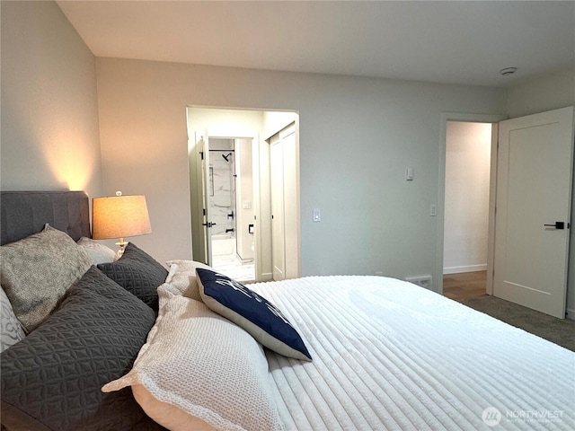 bedroom featuring baseboards and carpet