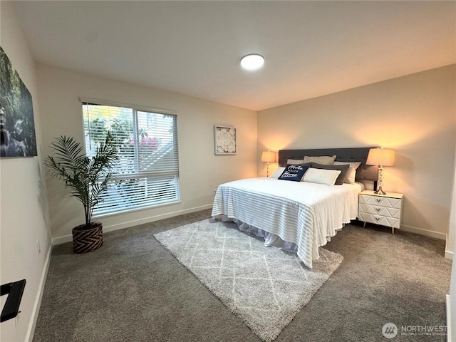 bedroom with baseboards and dark colored carpet
