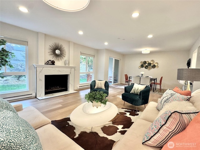 10221 NE 16th St Unit H5, Bellevue, WA 98004 - living room featuring recessed lighting, a healthy amount of sunlight, baseboard heating, and wood finished floors