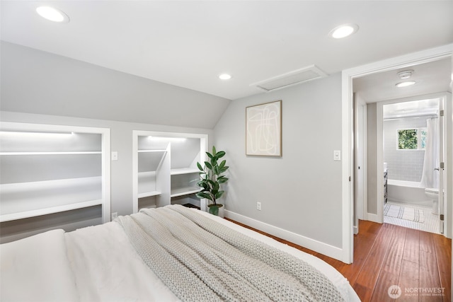 bedroom with wood finished floors, attic access, recessed lighting, baseboards, and lofted ceiling