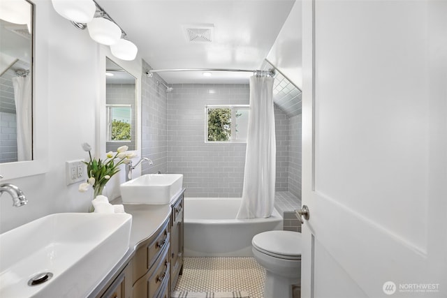full bathroom with shower / tub combo with curtain, tile patterned flooring, toilet, and double vanity