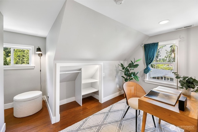 office with baseboards, vaulted ceiling, and wood finished floors