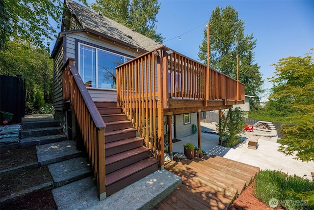 back of property featuring stairs, a patio area, a deck, and roof with shingles