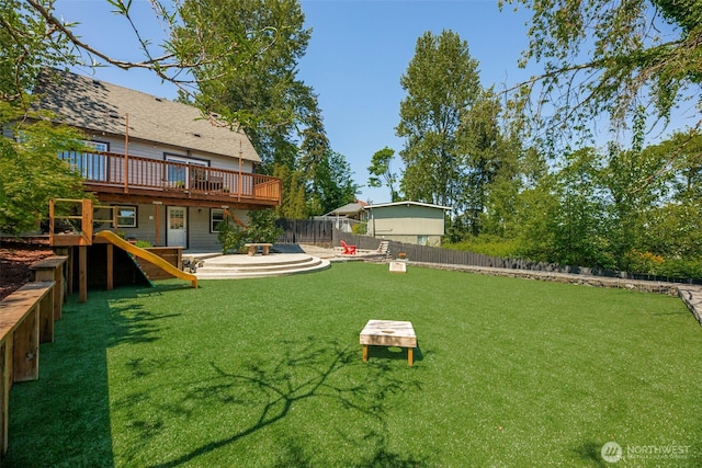 view of yard featuring a wooden deck and a dog friendly area