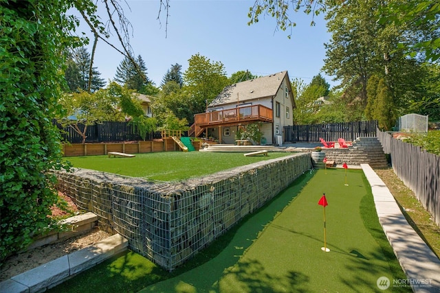 view of home's community with an area to practice putting and a wooden deck