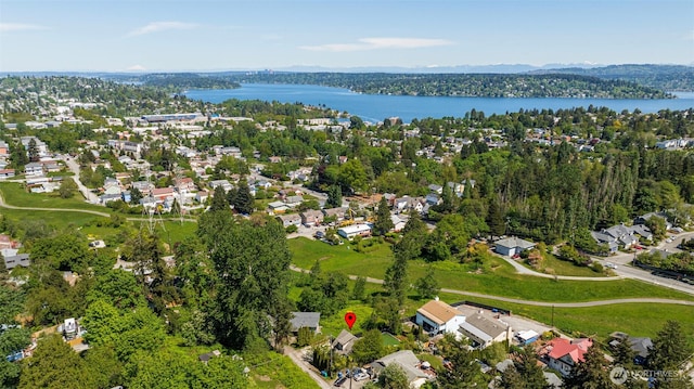 aerial view of property and surrounding area with a nearby body of water and nearby suburban area