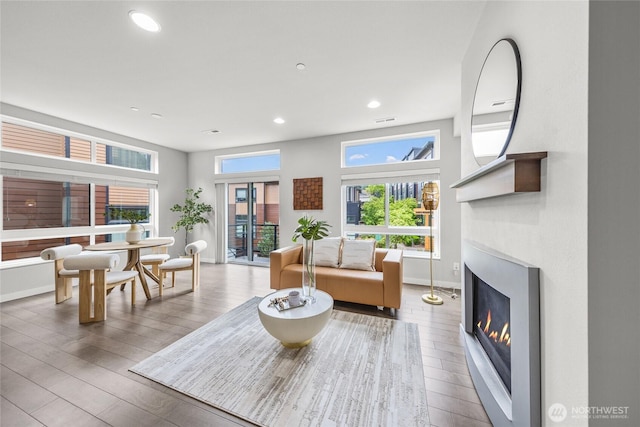 2055 NW Talus Dr Unit 3, Issaquah, WA 98027 - living room with a glass covered fireplace, wood finished floors, recessed lighting, and baseboards