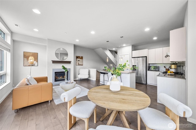 2055 NW Talus Dr Unit 3, Issaquah, WA 98027 - dining room with wood finished floors, recessed lighting, a glass covered fireplace, and baseboards
