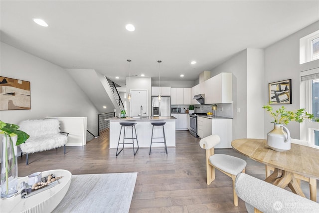 2055 NW Talus Dr Unit 3, Issaquah, WA 98027 - living area with wood finished floors, recessed lighting, and stairs