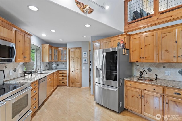 17613 Butler Rd, Snohomish, WA 98290 - kitchen featuring appliances with stainless steel finishes, a sink, light stone counters, decorative backsplash, and recessed lighting