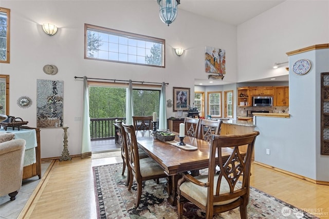 17613 Butler Rd, Snohomish, WA 98290 - dining room with a high ceiling, light wood-style floors, and baseboards
