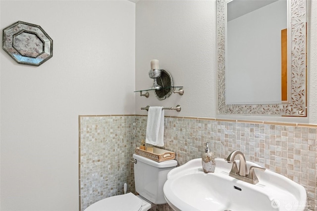 17613 Butler Rd, Snohomish, WA 98290 - bathroom featuring a sink, toilet, tile walls, and a wainscoted wall