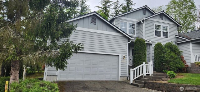 view of front of house with a garage, board and batten siding, and aphalt driveway