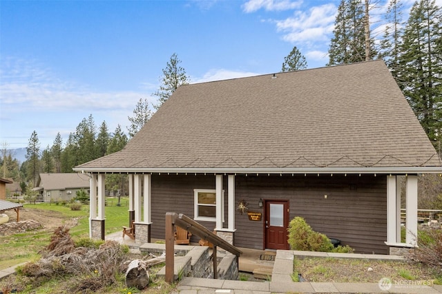 view of front of property featuring roof with shingles
