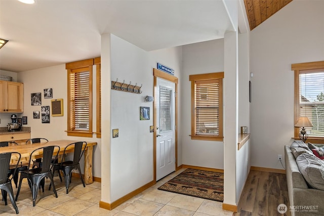 foyer entrance featuring light tile patterned floors and baseboards