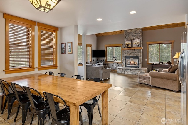 dining area featuring light tile patterned floors, a fireplace, and recessed lighting