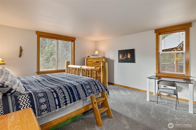 carpeted bedroom featuring baseboards