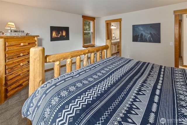 carpeted bedroom featuring ensuite bath
