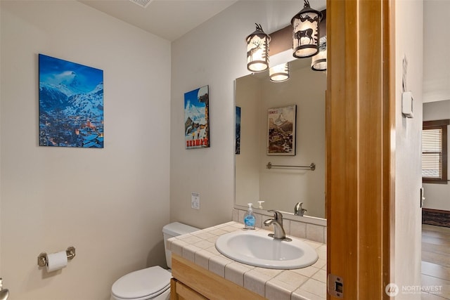 bathroom with toilet and vanity