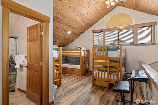 bedroom with lofted ceiling, wood ceiling, baseboards, and wood finished floors