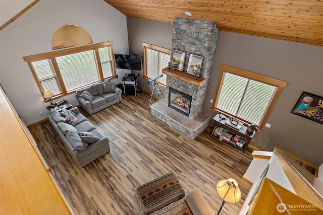 living room with wooden ceiling, wood finished floors, vaulted ceiling, and a fireplace