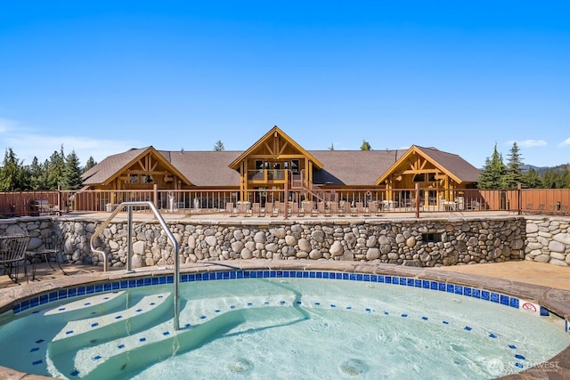 view of pool featuring fence, a patio, and a pool