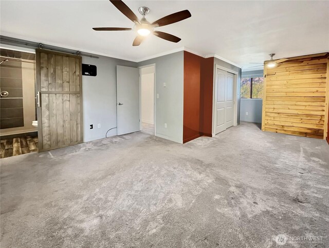unfurnished bedroom with ornamental molding, carpet flooring, and ceiling fan