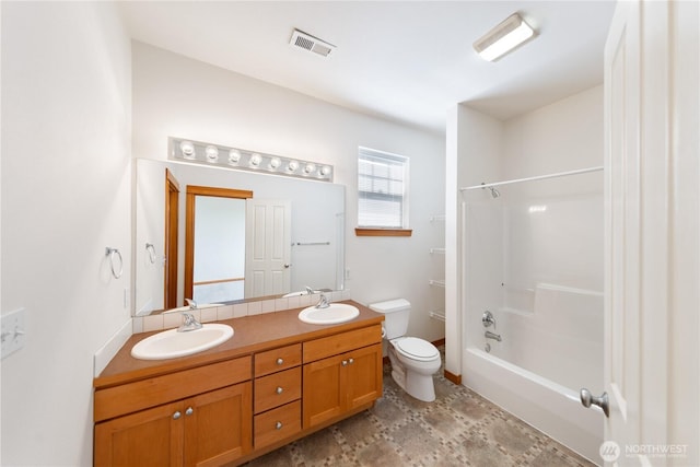 full bathroom with a sink, toilet, double vanity, and visible vents
