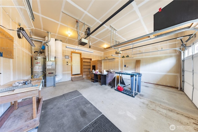 garage featuring a garage door opener and water heater