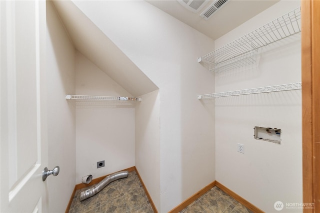 clothes washing area featuring laundry area, visible vents, baseboards, electric dryer hookup, and washer hookup