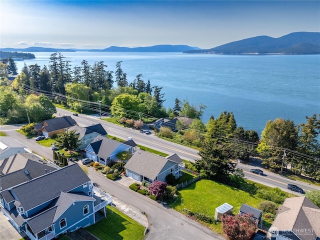 bird's eye view with a water and mountain view and a residential view