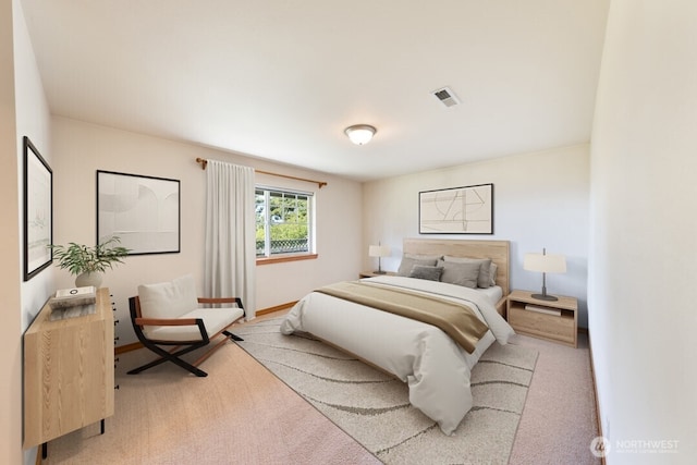 bedroom with visible vents, carpet, and baseboards