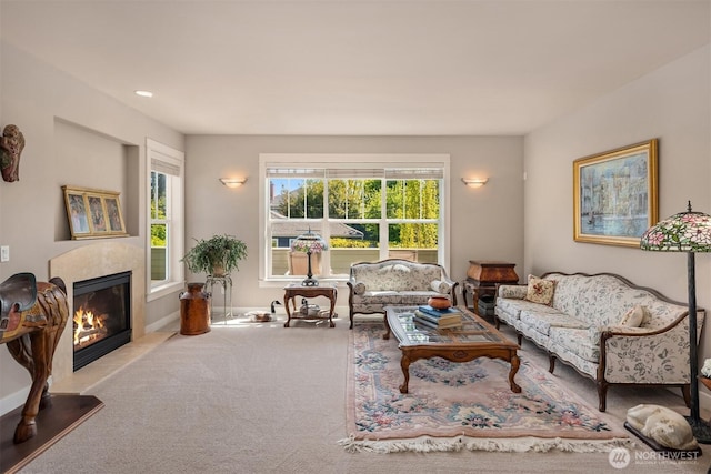 carpeted living area with a fireplace
