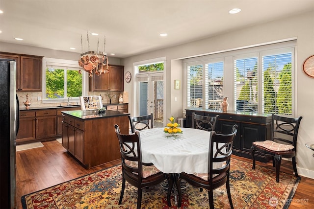 dining space with plenty of natural light, recessed lighting, dark wood finished floors, and a chandelier
