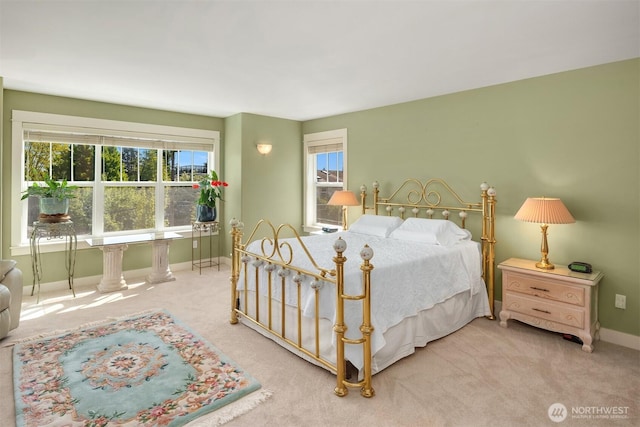 bedroom with baseboards, multiple windows, and carpet floors