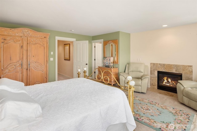 bedroom with a high end fireplace and carpet