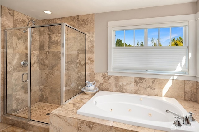 full bath featuring a shower stall and a jetted tub
